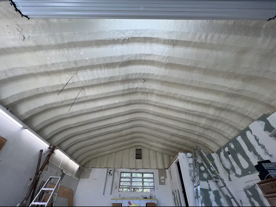 Spray polyurethane foam applied to the underside of a metal roof deck in Clinton